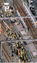 Workers begin clearing the track